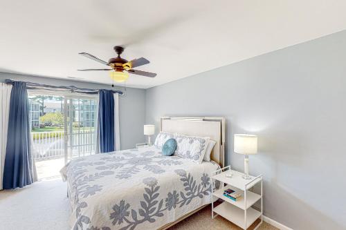 a bedroom with a bed and a ceiling fan at The Tides --- 19979 Sandy Bottom Cir, Unit #502 in Rehoboth Beach