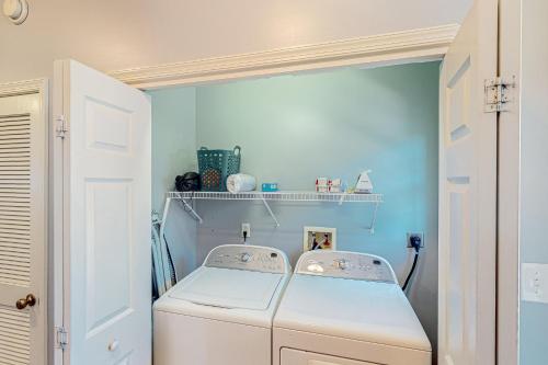 a laundry room with a washing machine in it at The Tides --- 19979 Sandy Bottom Cir, Unit #502 in Rehoboth Beach