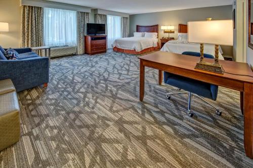 a hotel room with a bed and a desk at Hampton Inn & Suites Stuart-North in Stuart