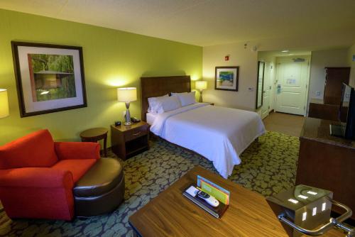 a hotel room with a bed and a chair at Hilton Garden Inn Exton-West Chester in Exton