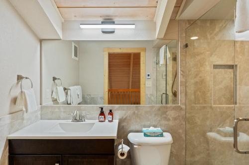 a bathroom with a sink and a toilet and a shower at Yampa View 307 in Steamboat Springs