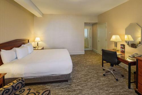 a hotel room with a bed and a desk at Hilton Cincinnati Netherland Plaza in Cincinnati