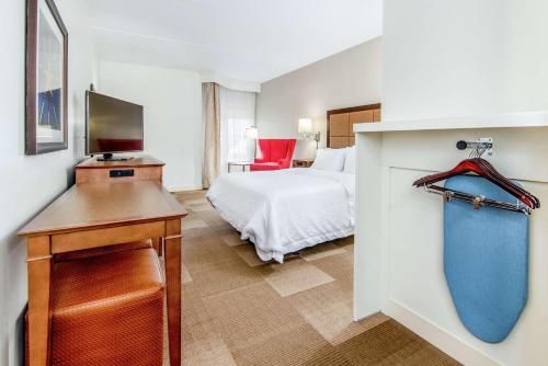 a bedroom with a bed and a desk with a television at Hampton Inn & Suites Bethlehem in Bethlehem
