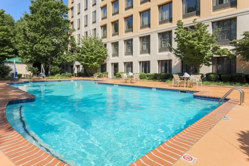 a large swimming pool in front of a building at DoubleTree by Hilton Atlanta Airport in Atlanta