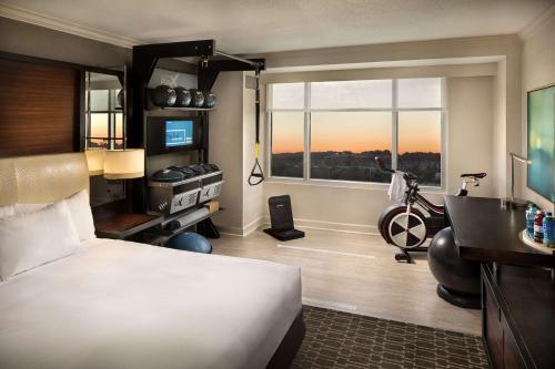 a hotel room with a bed and a desk and a window at DoubleTree by Hilton Atlanta Airport in Atlanta