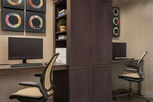 a office with two chairs and a desk with a computer at Home2 Suites By Hilton Chicago River North in Chicago