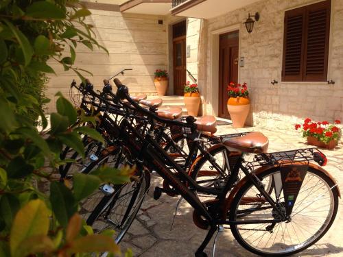a group of bikes parked outside of a house at Bed & Breakfast AMATI in Fasano