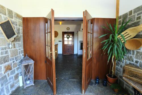 a hallway with doors and a plant in a room at Penzion Marie - Žumberk in Žumberk