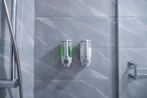 a bathroom with two soap dispensers on a wall at RESIDENZA ESPOSITO in Naples