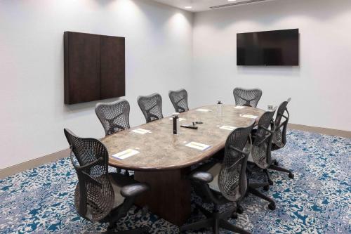 a conference room with a table and chairs at Hilton Garden Inn Detroit/Novi in Novi