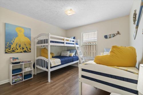 a bedroom with two bunk beds and a ladder at The Splash Pad Sleeps 13 w Pool Patio and Garage in Panama City