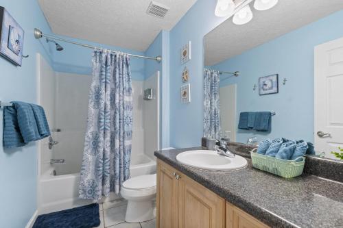 a bathroom with a sink and a toilet at The Splash Pad Sleeps 13 w Pool Patio and Garage in Panama City