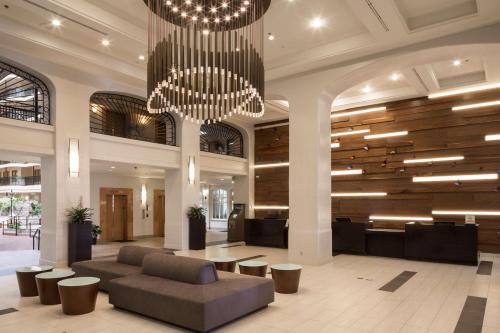a lobby with a couch and a chandelier at Embassy Suites by Hilton Anaheim North in Anaheim
