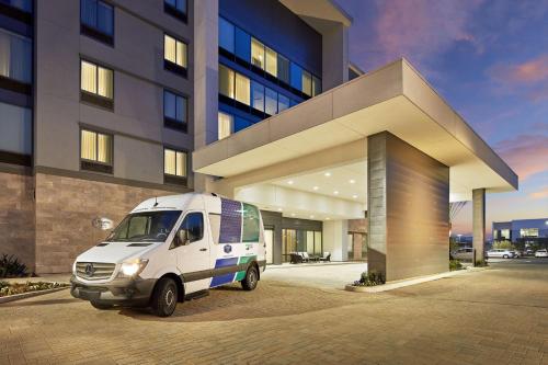 a white van parked in front of a building at Homewood Suites By Hilton Long Beach Airport in Long Beach