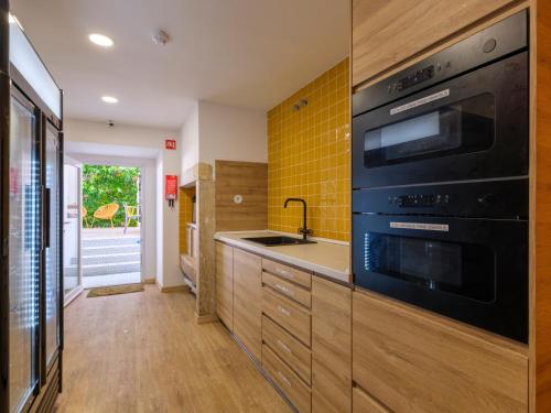 a kitchen with a sink and a stove at Lisbon Chillout Hostel in Lisbon