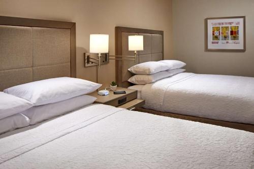 a hotel room with two beds and two lamps at Hampton Inn Long Beach Airport, Ca in Long Beach