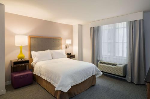 a hotel room with a bed and a window at Hampton Inn Manhattan - Times Square South in New York