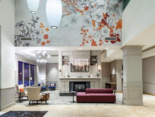 a lobby with a couch and a fireplace at Hilton Garden Inn Omaha Downtown-Old Market Area in Omaha