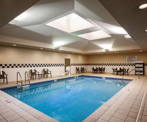 a pool with tables and chairs in a hotel room at Hilton Garden Inn Omaha Downtown-Old Market Area in Omaha