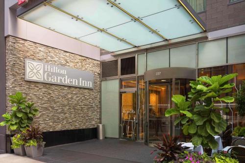 a building with a sign that reads luton garden inn at Hilton Garden Inn New York Central Park South-Midtown West in New York