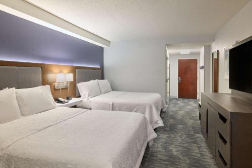 a hotel room with two beds and a flat screen tv at Hampton Inn Washington DC - Convention Center in Washington