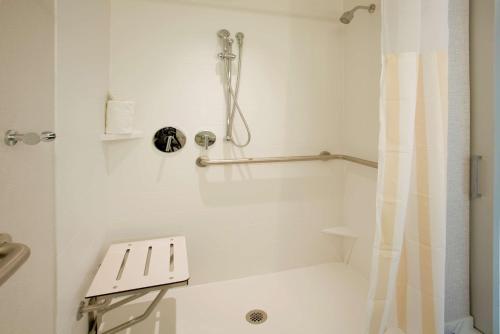 a white bathroom with a shower and a toilet at Hilton Garden Inn New York Central Park South-Midtown West in New York