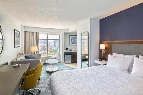 a hotel room with a bed and a desk at Hampton Inn Washington DC - Convention Center in Washington