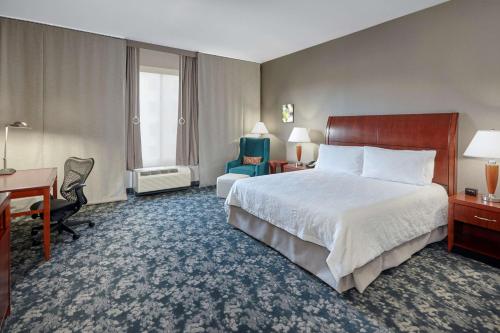 a hotel room with a bed and a desk at Hilton Garden Inn Lake Forest Mettawa in Lake Forest