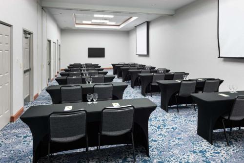 a room with rows of tables and chairs at Hilton Garden Inn Lake Forest Mettawa in Lake Forest