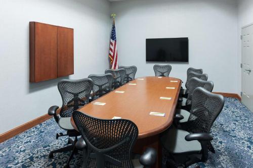a conference room with a wooden table and chairs at Hilton Garden Inn Lake Forest Mettawa in Lake Forest