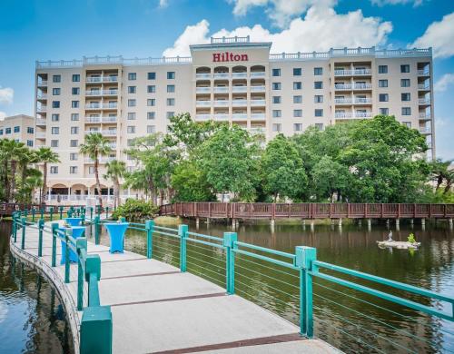 a hotel in front of a body of water at Hilton St. Petersburg Carillon Park in St Petersburg