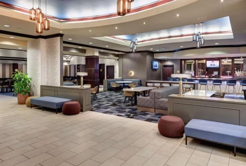 a lobby of a hotel with tables and chairs at Embassy Suites by Hilton Tampa Brandon in Tampa