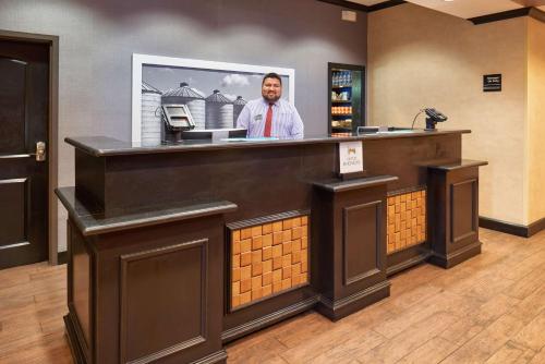 a man standing behind a bar in a hotel room at Hampton Inn & Suites Waco-South in Waco