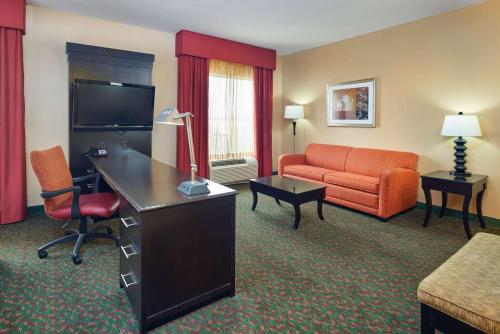 a hotel room with a couch and a desk in a room at Hampton Inn & Suites Waco-South in Waco