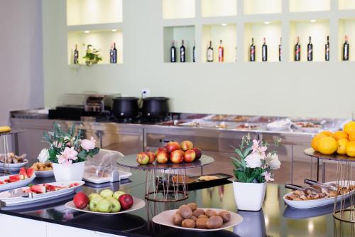 a buffet with many plates of food on a table at Hotel GRINT in Golem