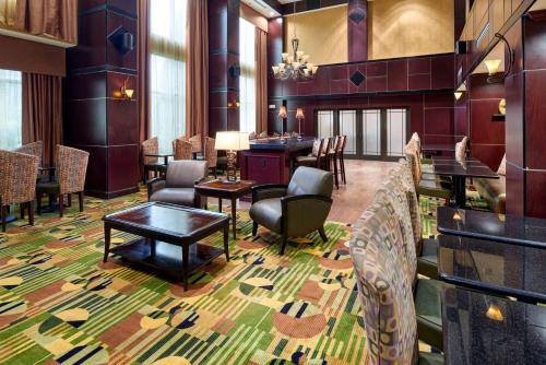 a lobby with a bar and tables and chairs at Hampton Inn & Suites Austin South Buda in Buda