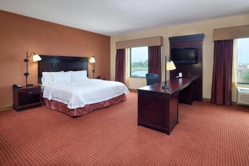 a hotel room with a bed and a desk at Hampton Inn & Suites Austin South Buda in Buda