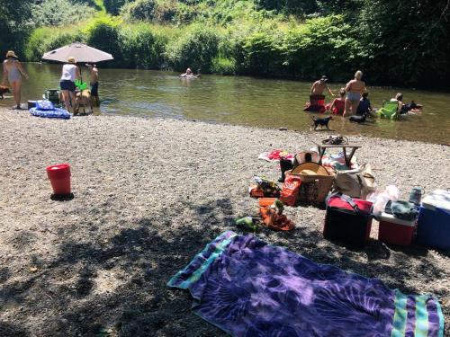 a group of people on a beach near a river at Historical Home, near wineries, weddings & shops in Snohomish