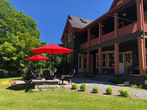 a house with two red umbrellas in front of it at Historical Home, near wineries, weddings & shops in Snohomish