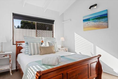 a bedroom with a bed and a large window at Pet friendly family escape in Coolum Beach