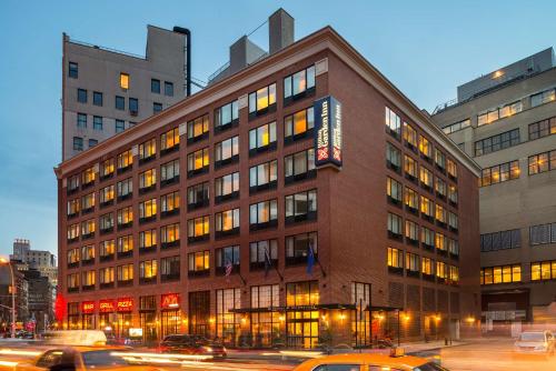 a large building with cars parked in front of it at AMTD Idea Tribeca in New York