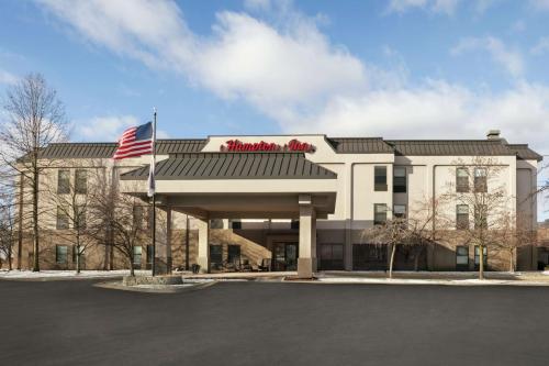a building with an american flag in front of it at Hampton Inn Binghamton/Johnson City in Binghamton
