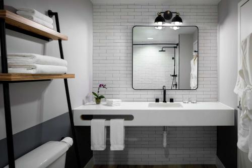 a bathroom with a white sink and a mirror at Freepoint Hotel Cambridge, Tapestry Collection by Hilton in Cambridge