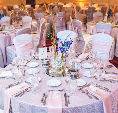a table set up for a wedding with white tables and chairs at Embassy Suites Cleveland - Beachwood in Beachwood