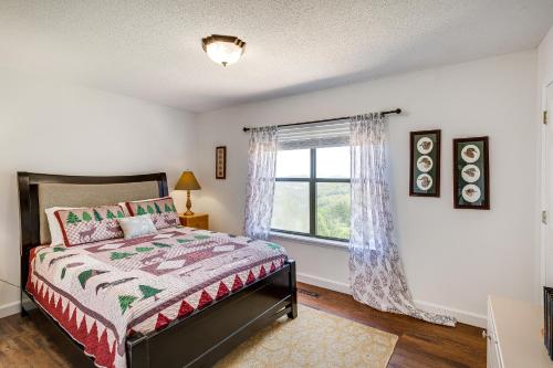 a bedroom with a bed and a window at Guntersville Hideaway with Mountain and Lake Views! in Albertville