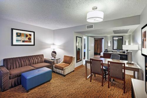 a living room with a couch and a table at Embassy Suites by Hilton Dallas Market Center in Dallas