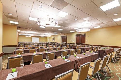 a large room with tables and chairs in it at Embassy Suites by Hilton Dallas Market Center in Dallas