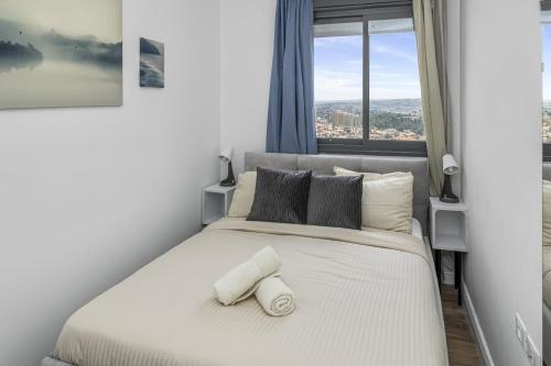 a bedroom with a white bed with a window at Jerusalem Luxury Apartments by IB Properties in Jerusalem