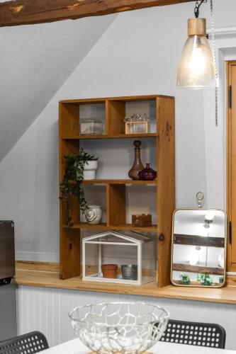 a wooden cabinet in a kitchen next to a table at L'Artisan - Vieux-Terrebonne in Terrebonne