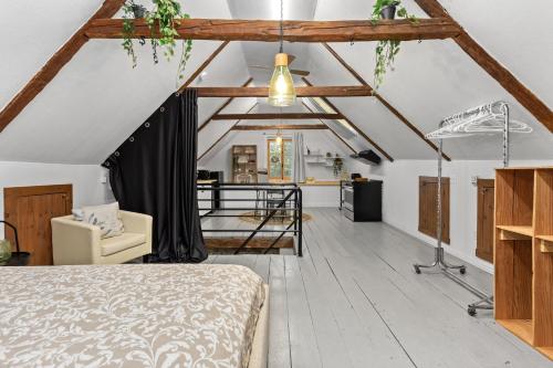 a bedroom with a bed and a living room at L'Artisan - Vieux-Terrebonne in Terrebonne